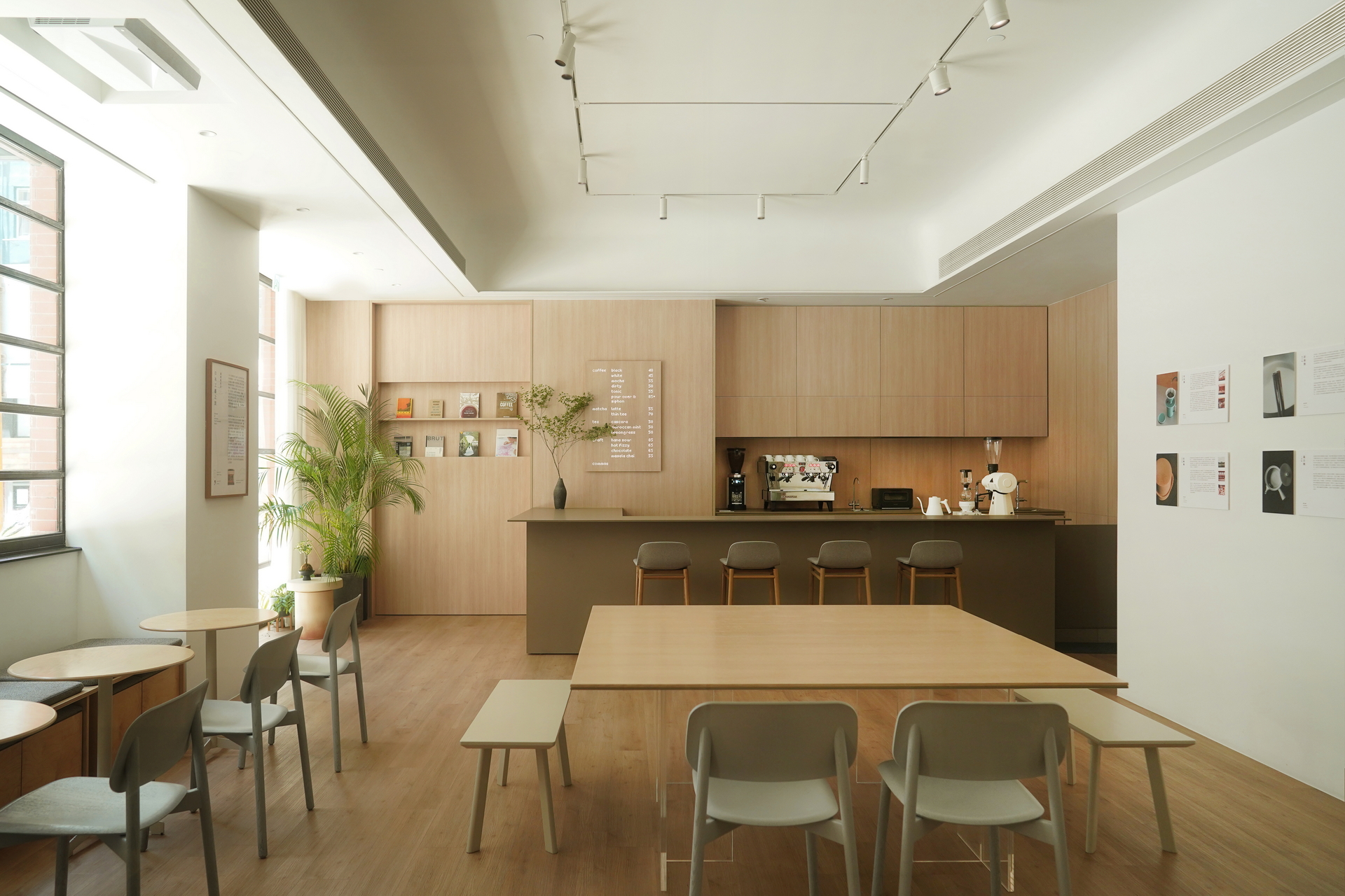 commaa’s light oak-and-white interior, communal tables and cantilevered coffee counter with its illuminated wood menu.