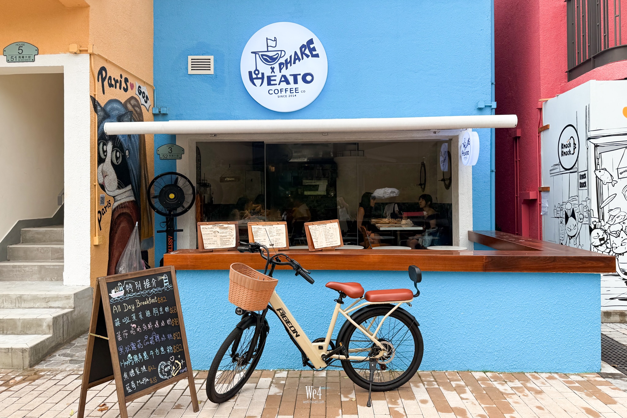 Heato x Phare’s bright blue frontage, white café sign, outdoor counter and bicycle; House 3 / 52 address plaque visible.