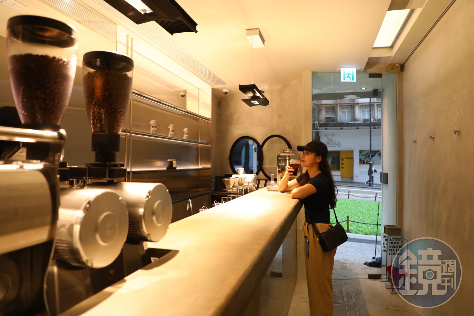 Project C’s narrow concrete coffee bar, grinders and a customer by the Hysan Avenue entrance.