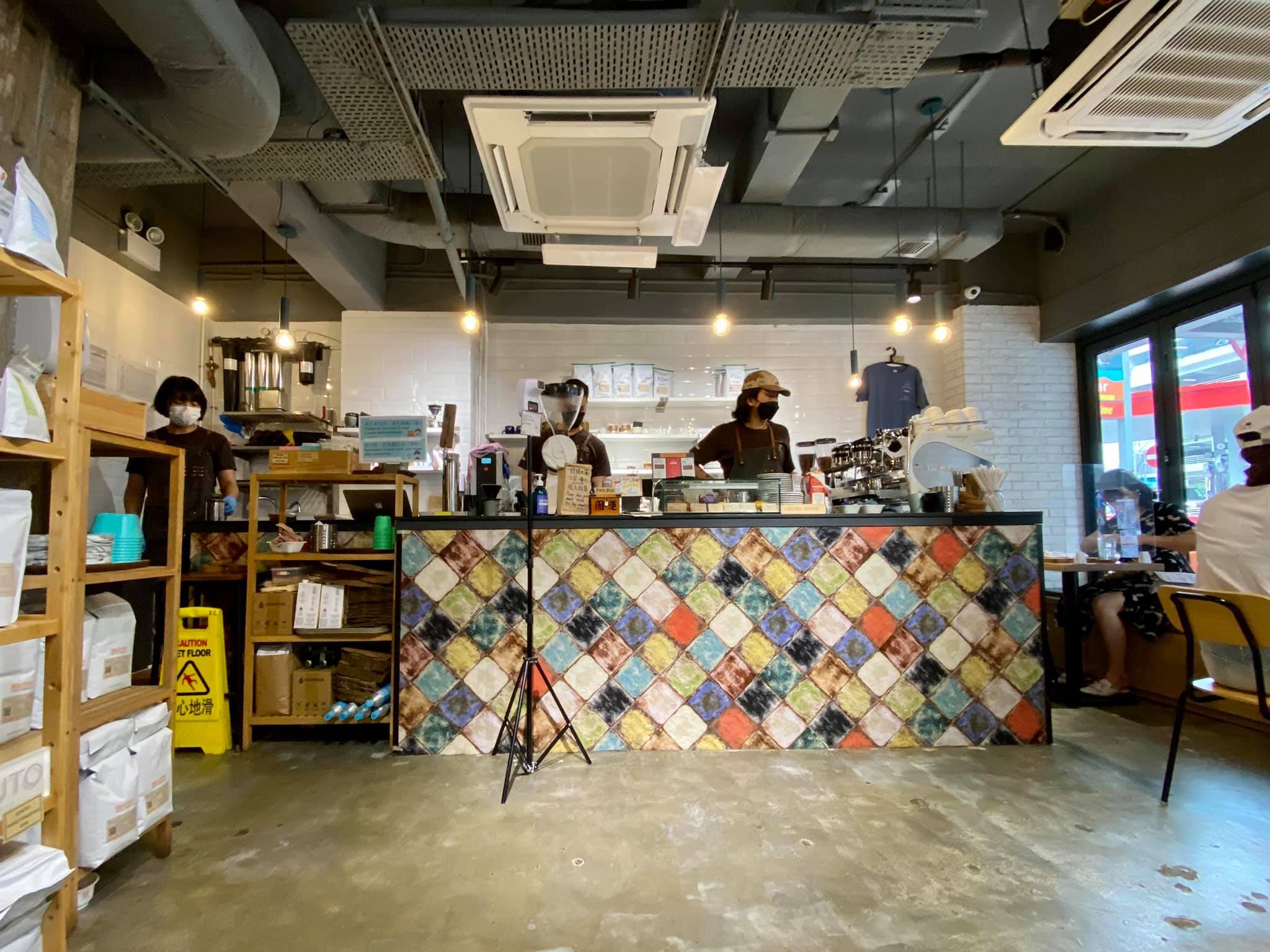 The multicoloured tiled coffee counter and seating inside REACTION Coffee Roasters in Happy Valley.