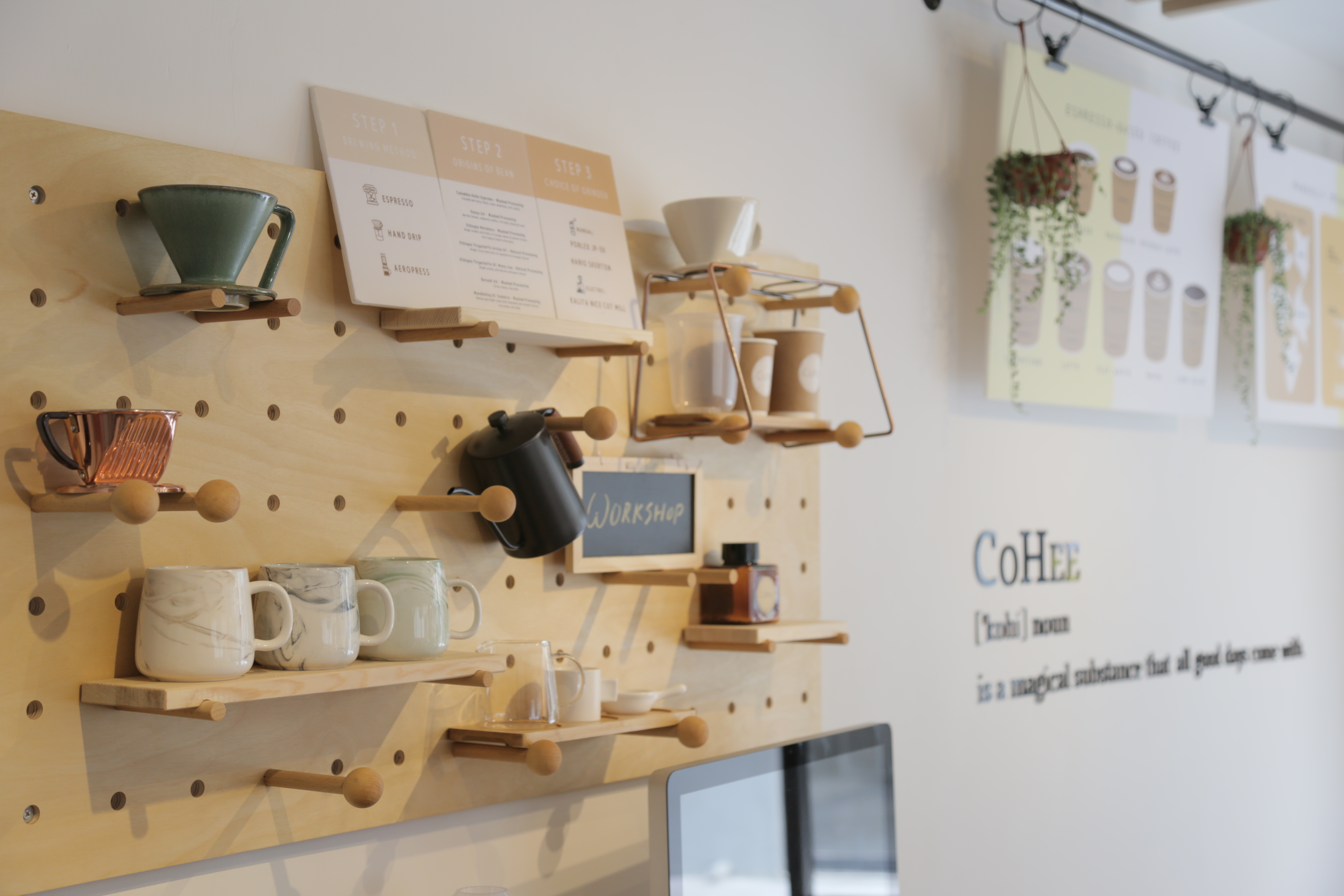 Coffee brewing equipment displayed on a pegboard inside CoHee Studio in Kam Tin.