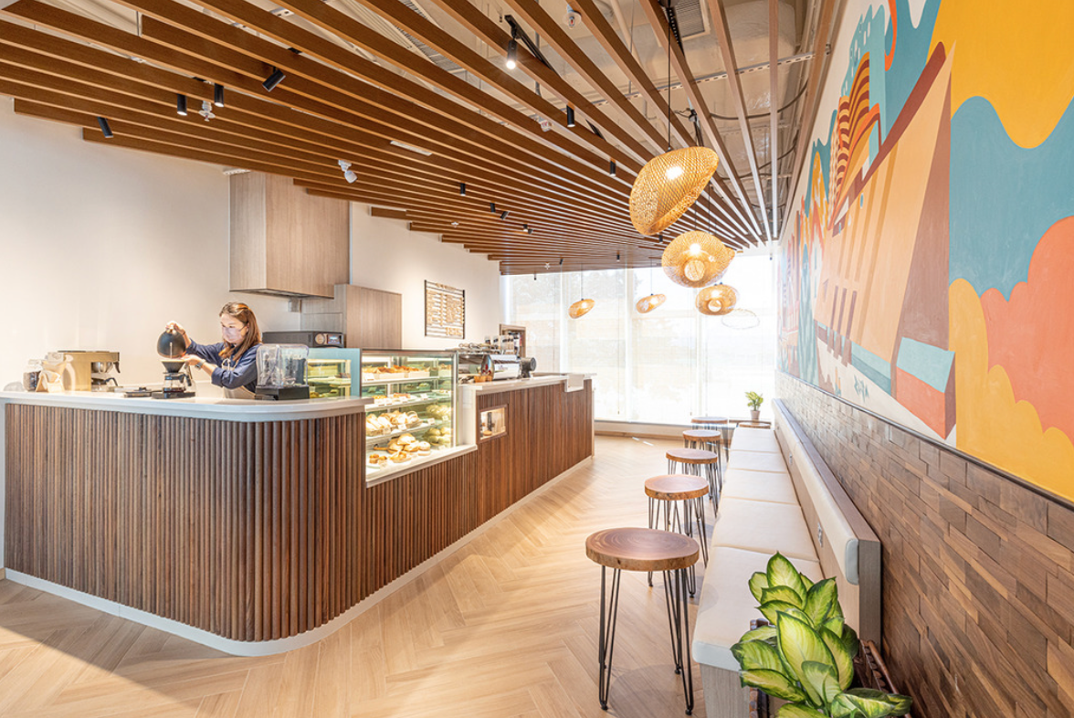 Wood-lined counter and mural inside Brentwood Coffee Roaster Kowloon Bay
