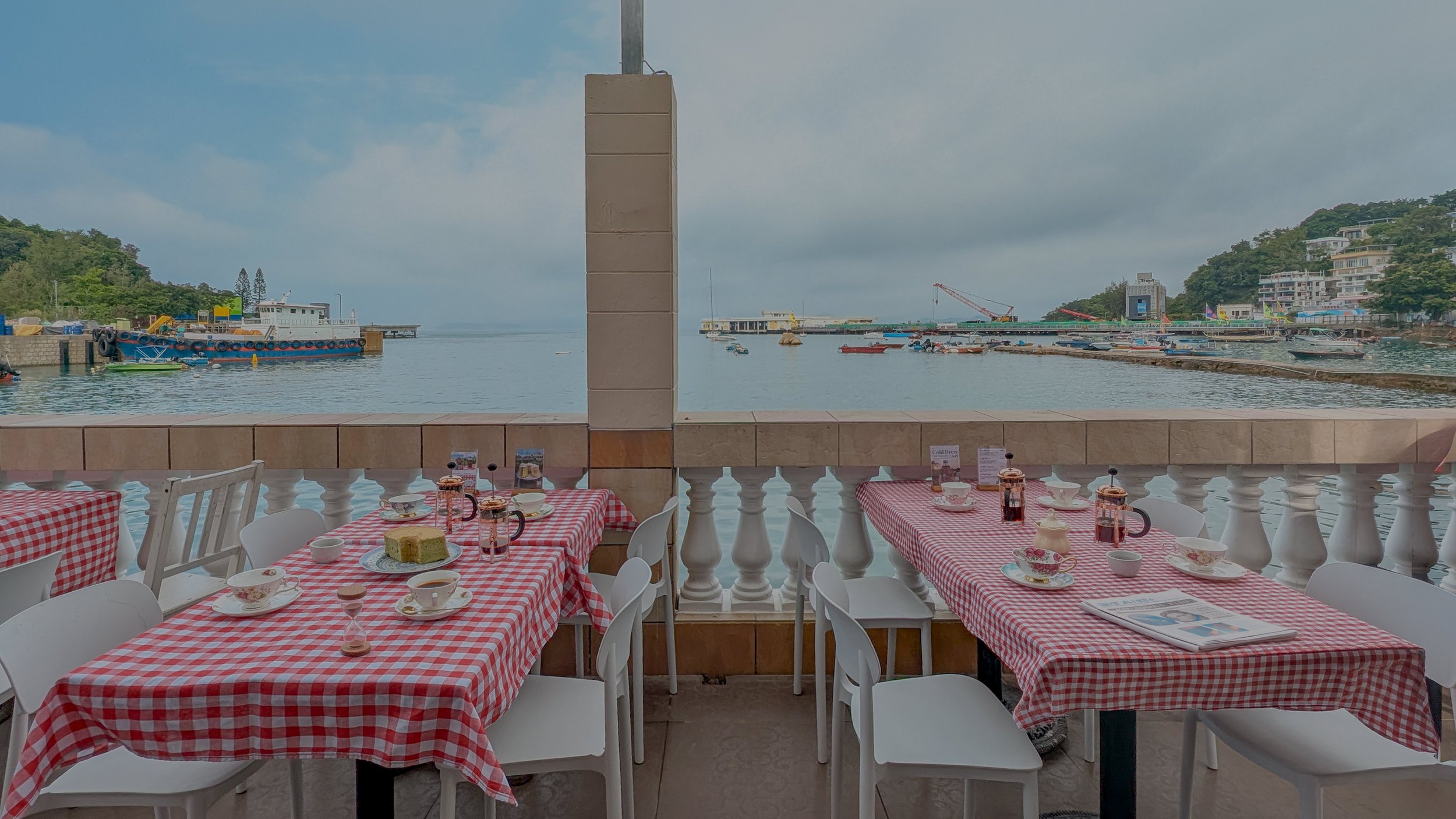Coffee tables overlooking Yung Shue Wan harbour at The Waterfront on Lamma Island.
