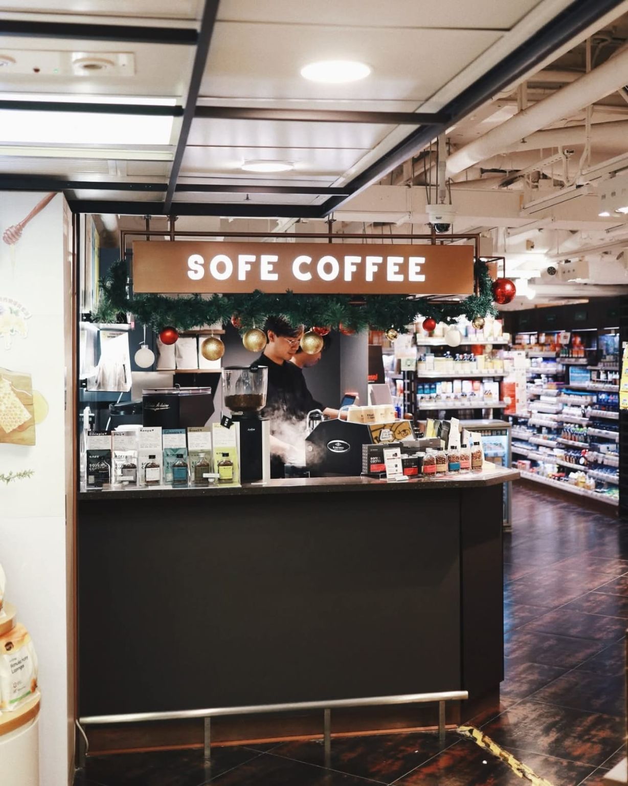 SOFE Coffee’s counter inside city’super at New Town Plaza, Sha Tin, with its illuminated sign and coffee display.