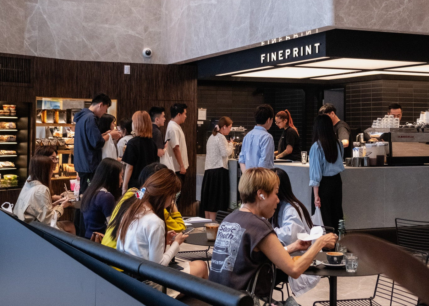 Customers at the long bar inside FINEPRINT at China Merchants Plaza in Sheung Wan.