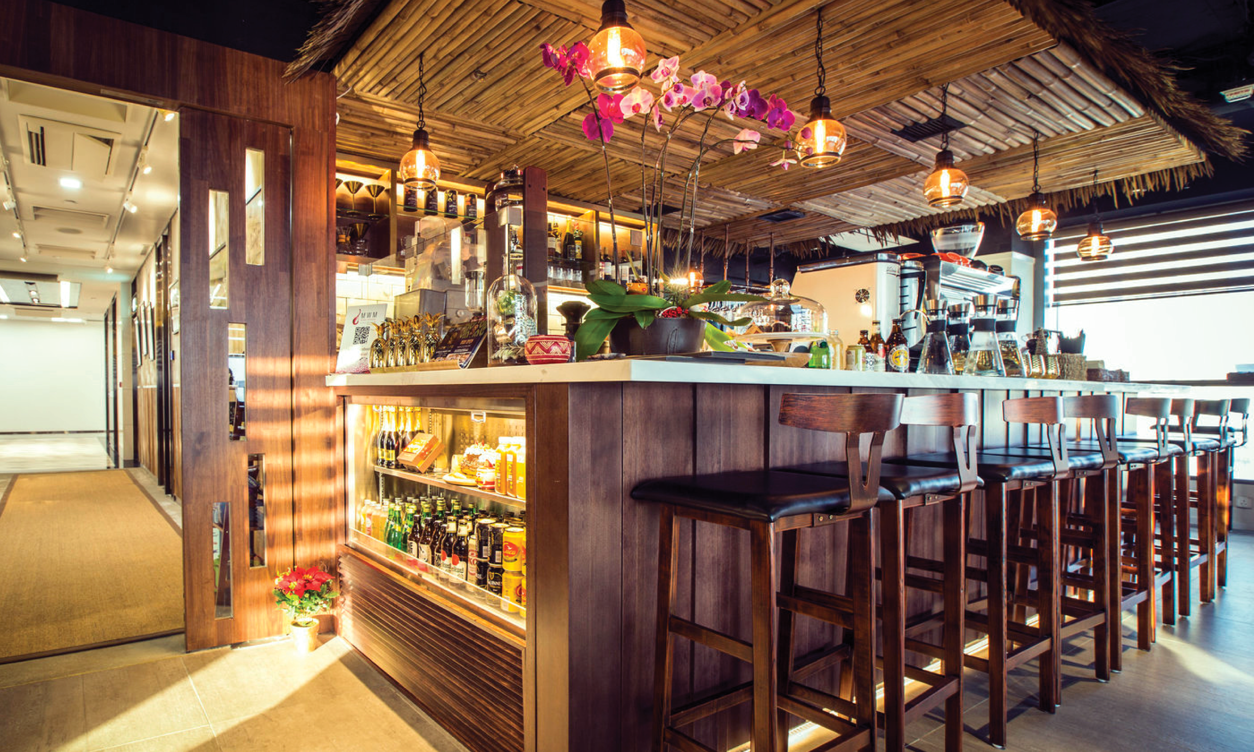 Wooden café bar and stools beneath a bamboo canopy at Africa Coffee & Tea in Wong Chuk Hang.
