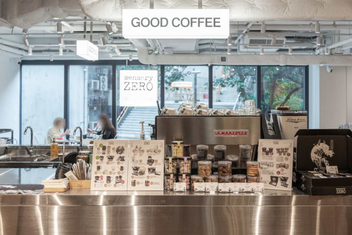 Stainless-steel espresso counter and window-side tables at sensory ZERO in Wong Chuk Hang.
